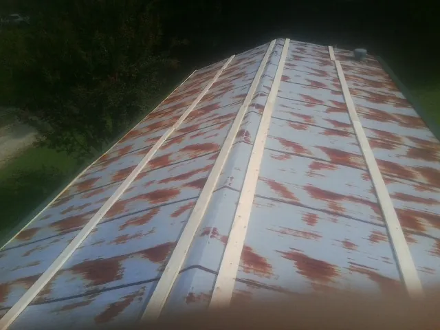 Rusted metal roof panels with new wood purlins before replacement — Storm Damage Roof Repair in Cawood by Roofing Brothers