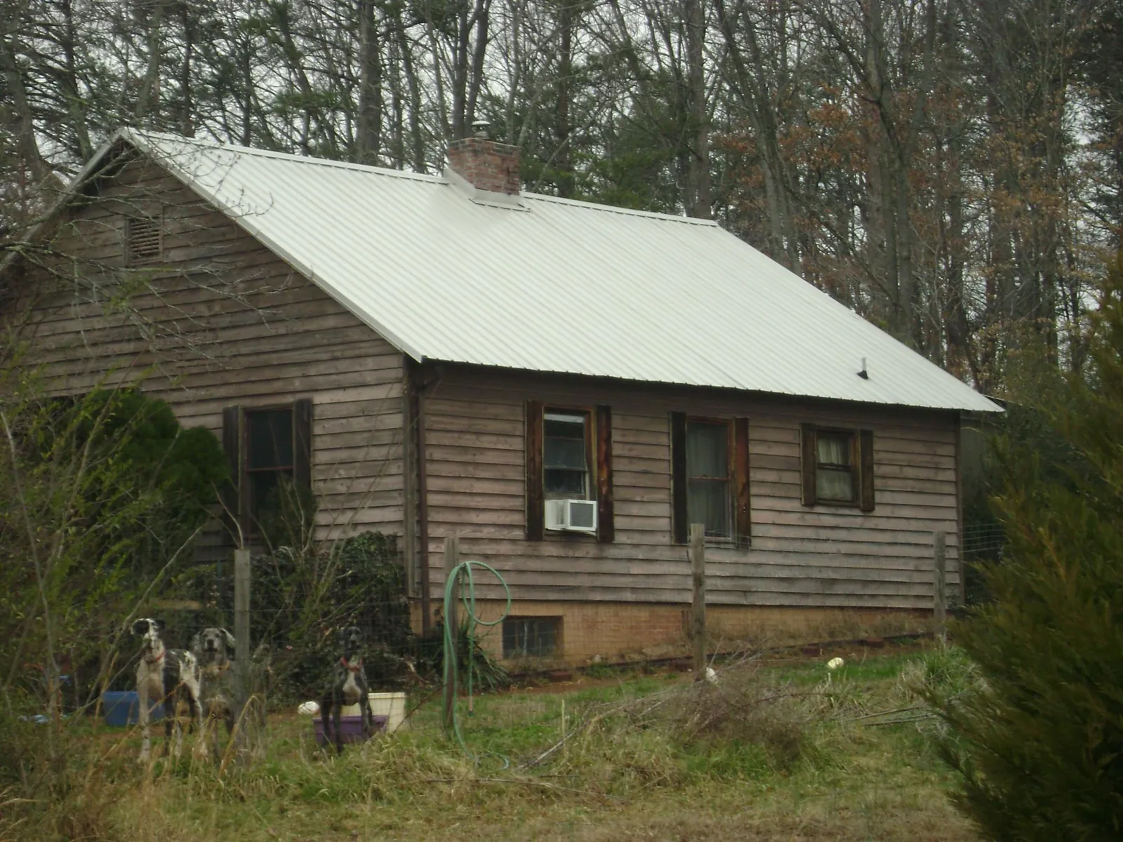 White metal roof on an old wood sided farmhouse, from a Metal Roof Installation job in Cawood